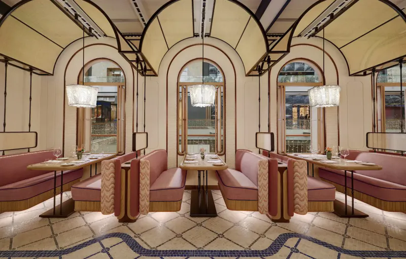 Elegant Paiza Collection dining area with arched ceilings, pink upholstered booths, tables, and pendant lamps.