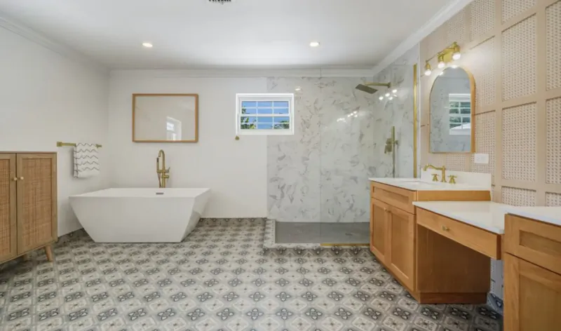 Modern bathroom in Ciao Bella, Lyford Cay: freestanding tub, marble walk-in shower, wood vanities, gold fixtures.