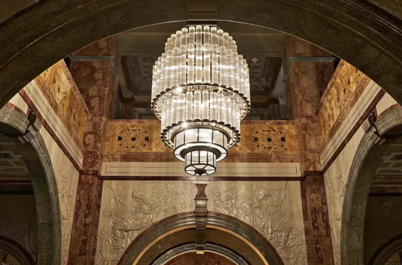 Ornate crystal chandelier hanging in grand arched ceiling of Kimpton Fitzroy London historic interior