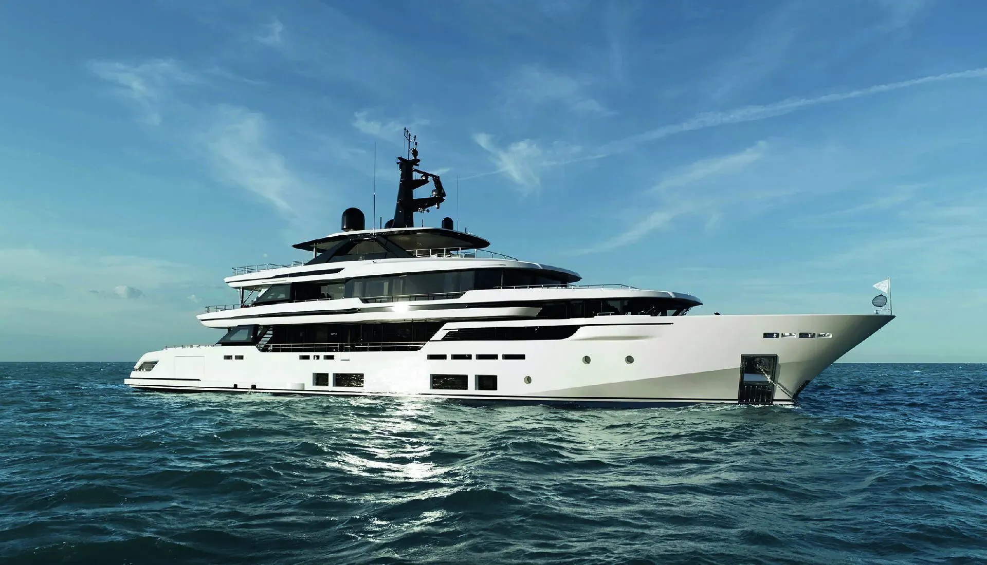 White multi-deck luxury yacht sailing on calm blue sea at Monaco Yacht Show 2024