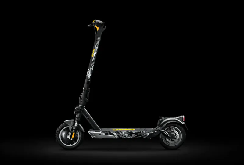 Side view of black Jeep Urban electric scooter with camouflage pattern and yellow accents on black background.