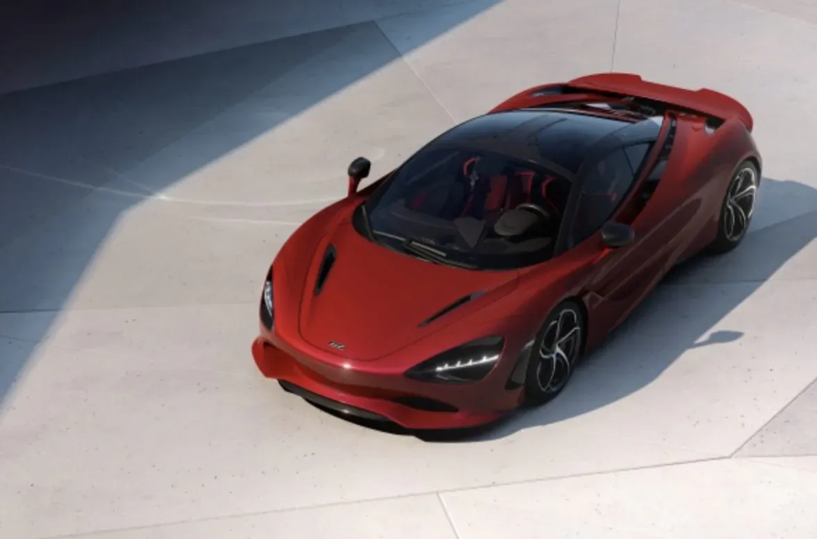Red McLaren 720S supercar with open top, angled view on showroom floor