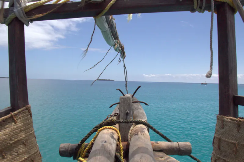 View from prow of traditional Kenyan dhow sailing over turquoise Indian Ocean in Kisite-Mpunguti Marine Park