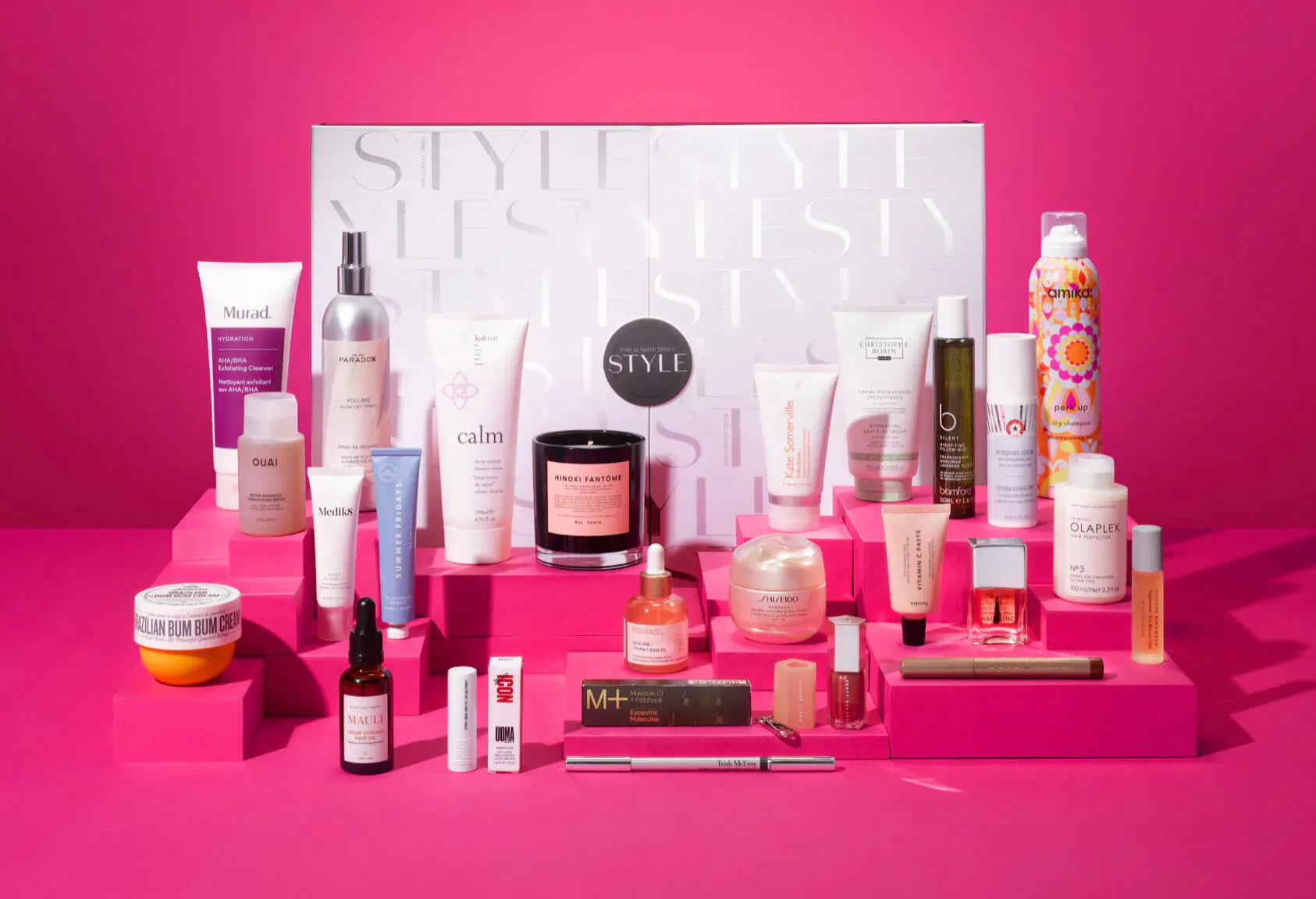 Sunday Riley 'STYLE' beauty advent calendar with skincare, makeup, and candle on pink display