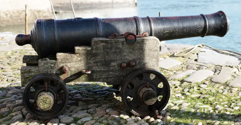 Rustic black cannon on wooden wheeled carriage positioned on cobblestone near blue sea