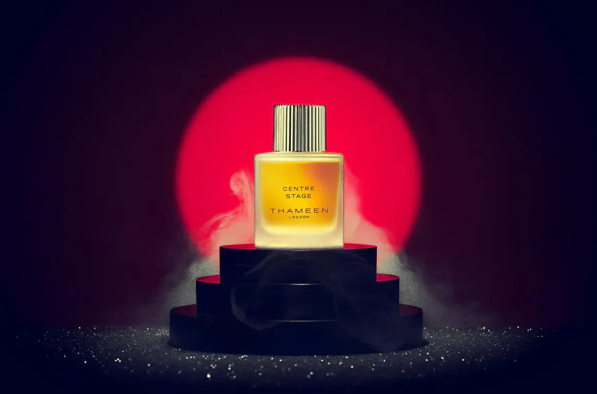 Thameen London Centre Stage perfume bottle on black pedestal with red sun glow and mist, from The Britologne Collection