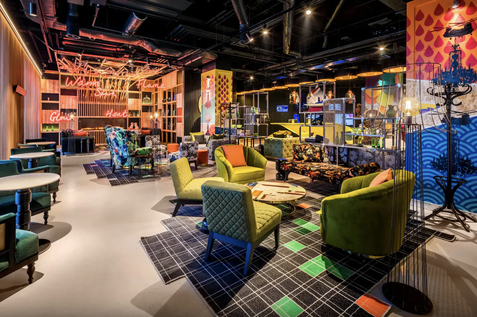 Vibrant nhow Hotel London lobby with punk-inspired colorful seating, high-tech neon art, and eclectic decor