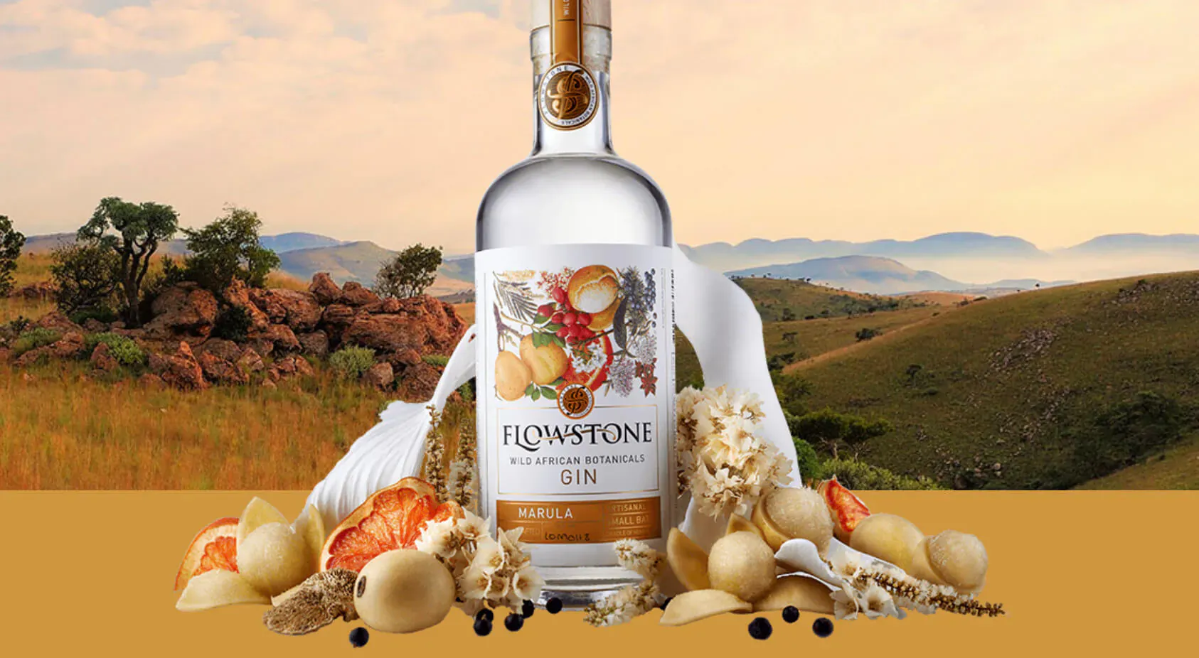Flowstone Gin bottle with oranges, nuts, and spices on a savanna landscape backdrop