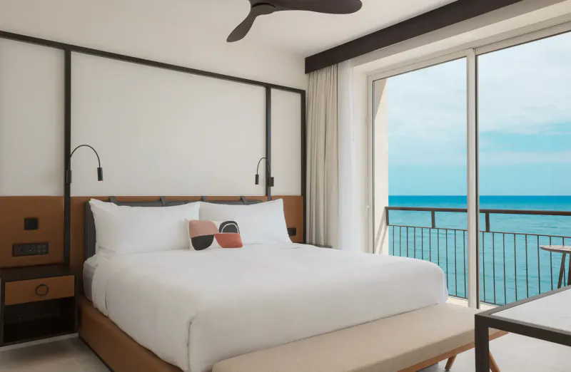 Luxurious Hotel Riomar bedroom in Ibiza with king bed, balcony, and ocean view.
