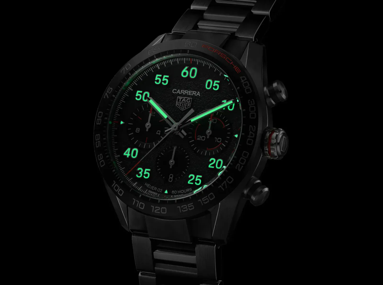 TAG Heuer Carrera Porsche chronograph watch with glowing green numerals on black dial and bracelet