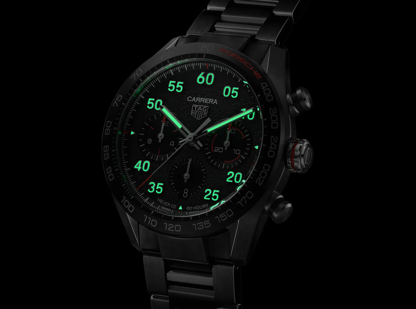 TAG Heuer Carrera Porsche chronograph watch with glowing green numerals on black dial and bracelet