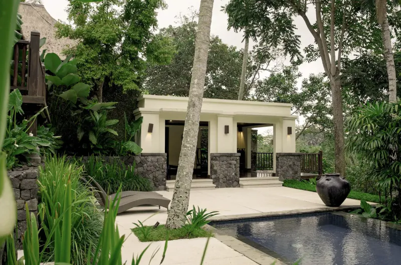 Modern white pavilion with open sides beside infinity pool in lush tropical garden, Bali villa overlooking Ayung River