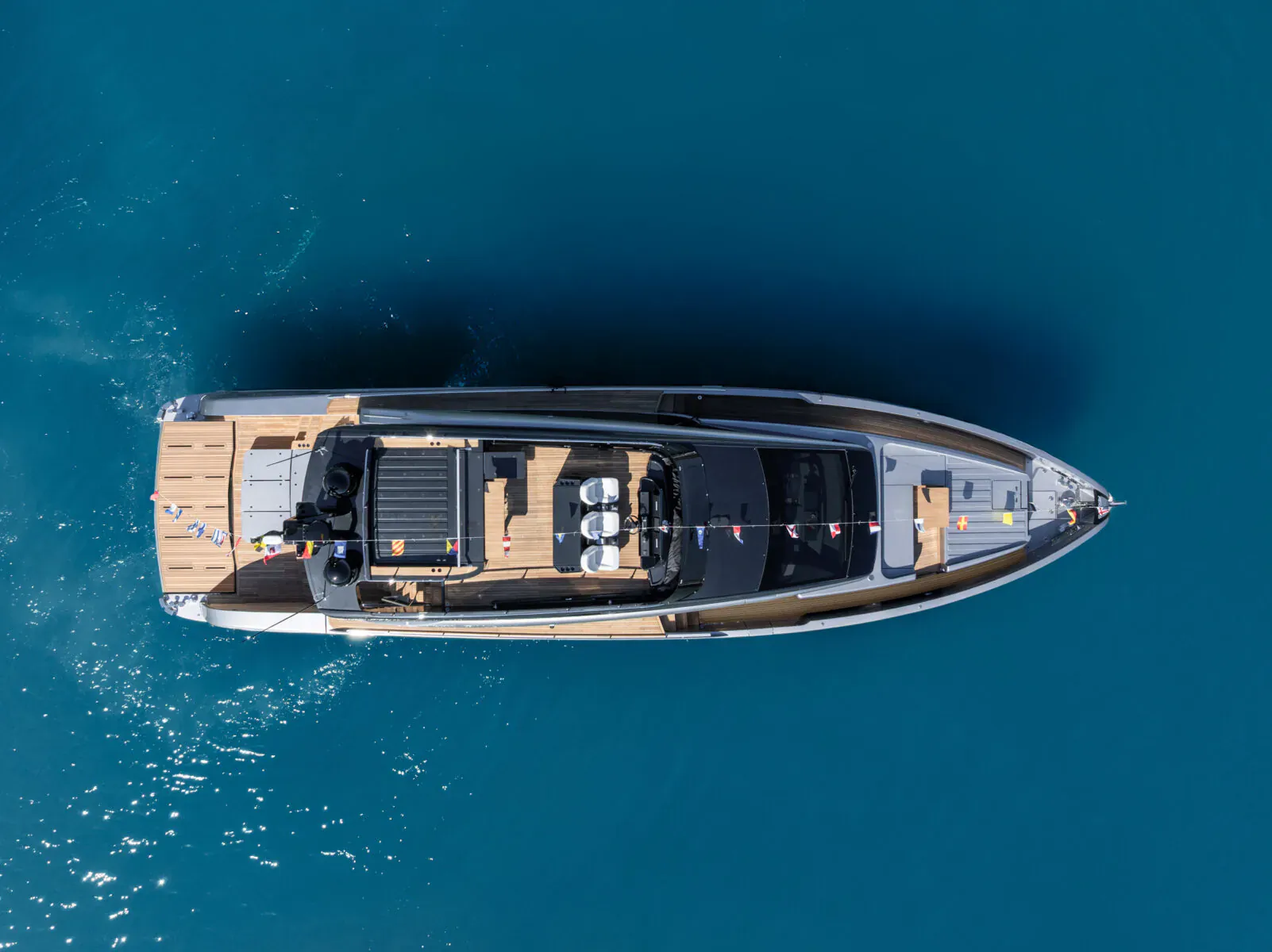 Aerial view of the first Pershing GTX70 luxury yacht launched on blue ocean waters.