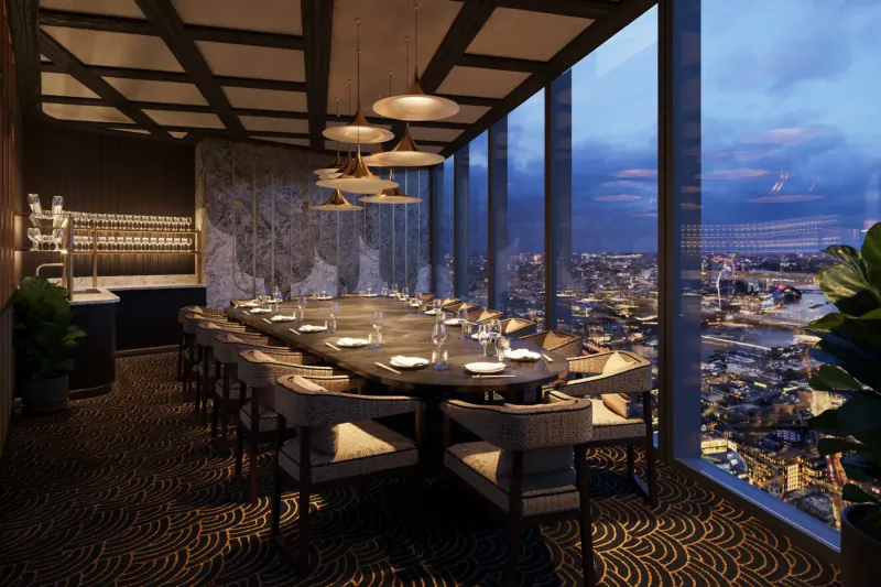 Elegant empty long dining table in Lucky Cat by Gordon Ramsay, with city skyline sunset view through floor-to-ceiling windows.