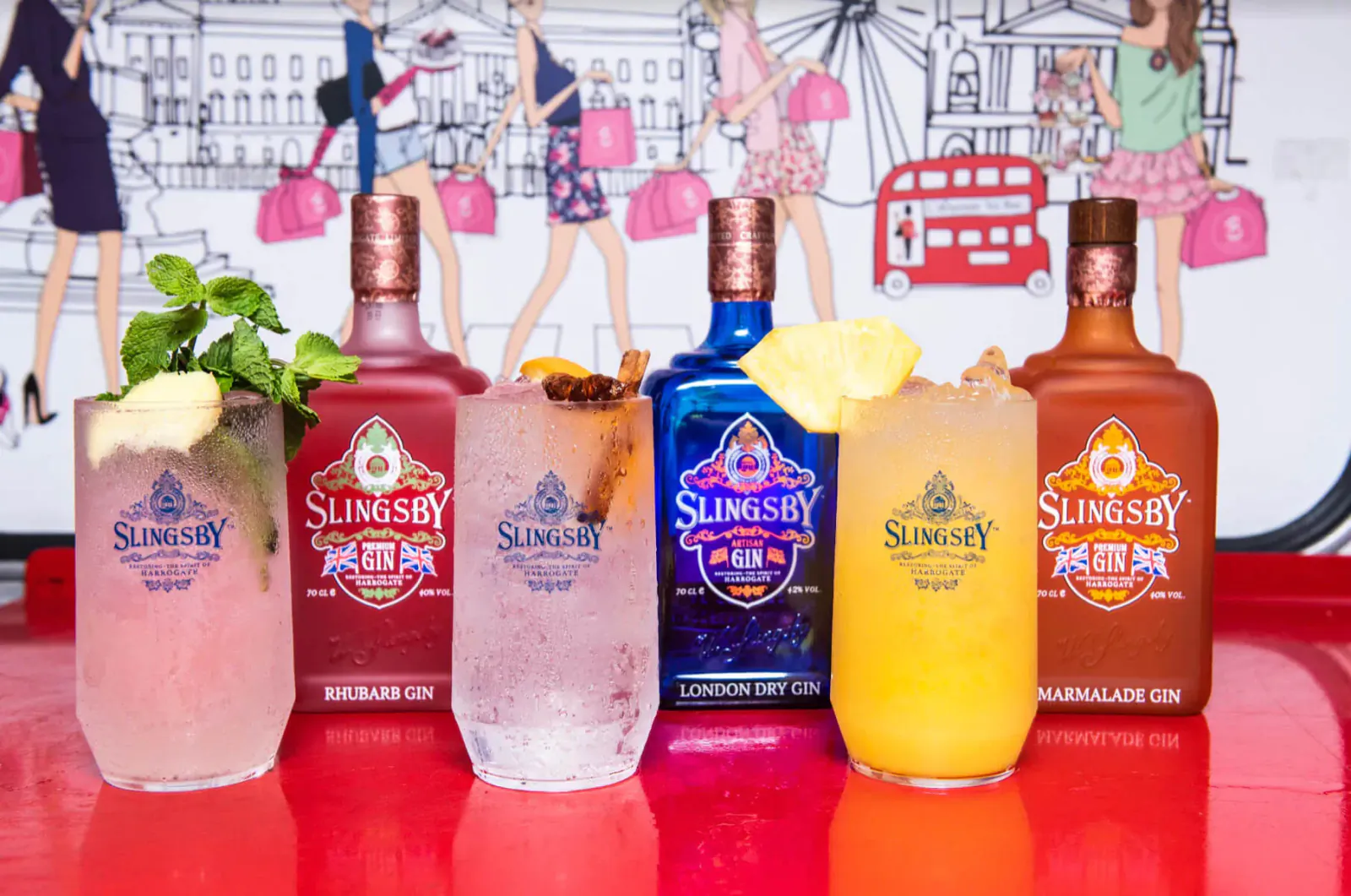 Slingsby Gin cocktails in pink, blue, orange on red tray with London bus and stylish women backdrop