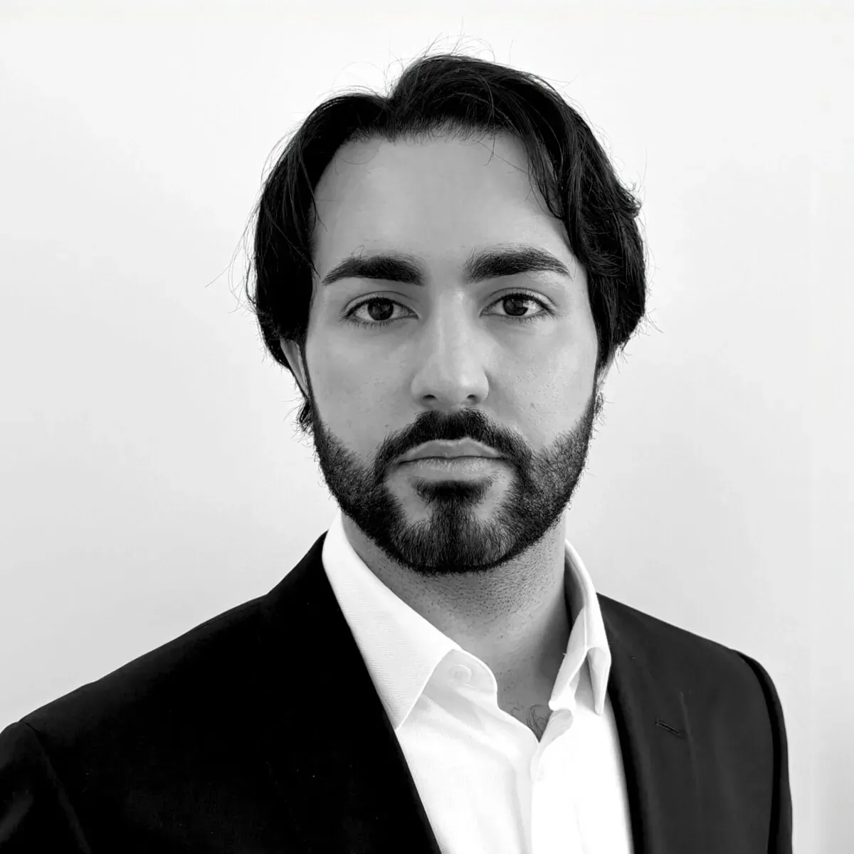 Black-and-white headshot of Dr. Thivos Sokratous in black suit and white shirt