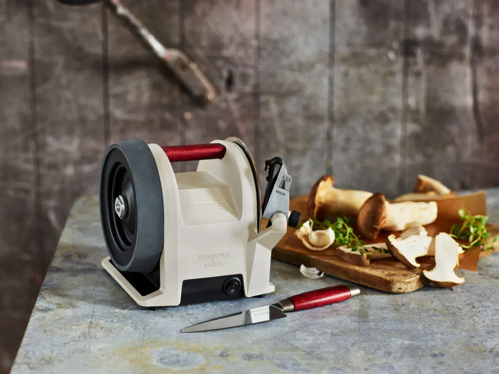 Tormek T-1 Morakniv 1891 Kitchen knife sharpener with mushrooms and sliced peels on wooden board