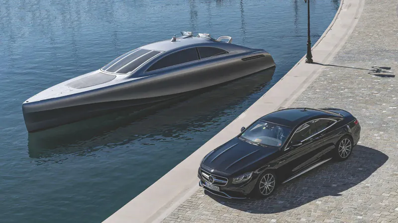 Silver Mercedes-Benz Style luxury yacht docked beside black Mercedes S-Class coupe on waterfront quay.