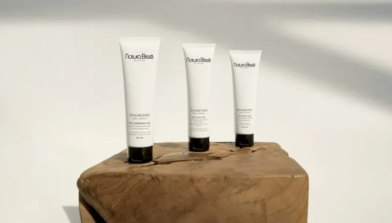 Three Natura Bissé Lipo-Gel Sculpting anti-cellulite firming gel tubes on wooden block.