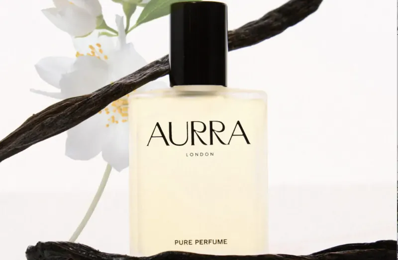AURRA London pure perfume bottle with white flowers and vanilla branch