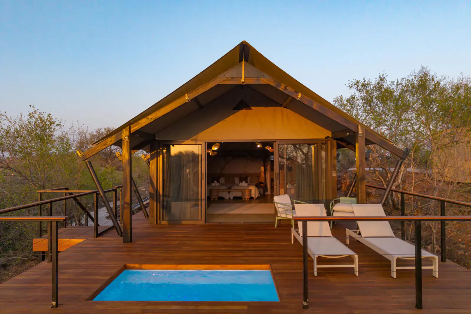 Luxury tented suite on elevated wooden deck with private pool, lounge chairs, and bushveld views at 18 On The Hill, Greater Kruger.