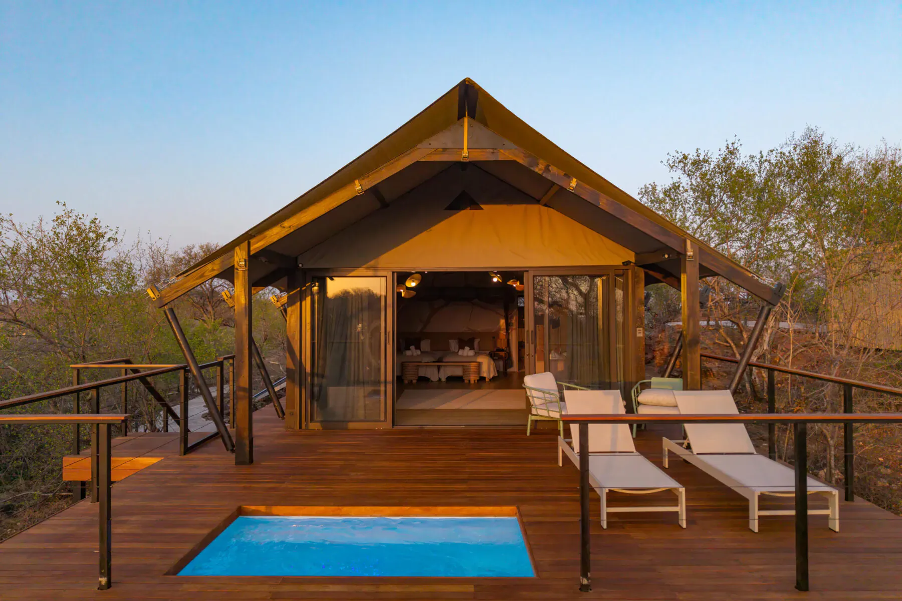 Luxury tented suite on elevated wooden deck with private pool, lounge chairs, and bushveld views at 18 On The Hill, Greater Kruger.