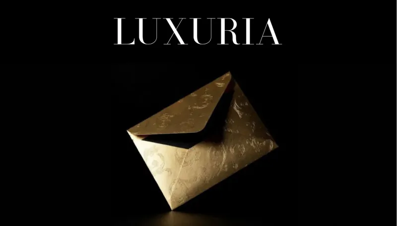 LUXURIA logo with elegant gold envelope on black background