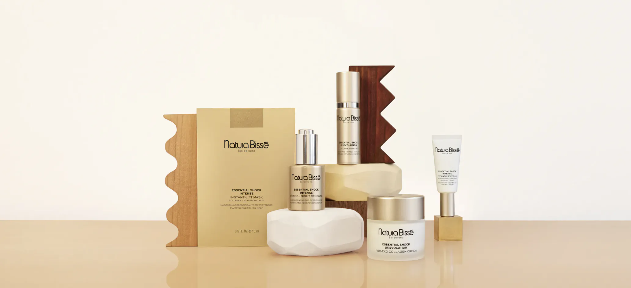 Vẻ Đẹp skincare products on table: serum, cream jars, soap bar, lotion tube, and gold stand with boxes.