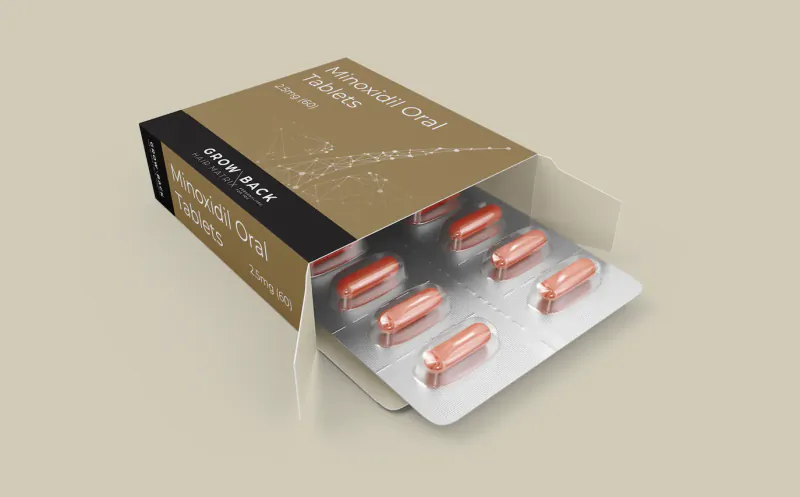 Open box of Minoxidil Oral Tablets 5mg/10mg showing blister pack with six pink capsules