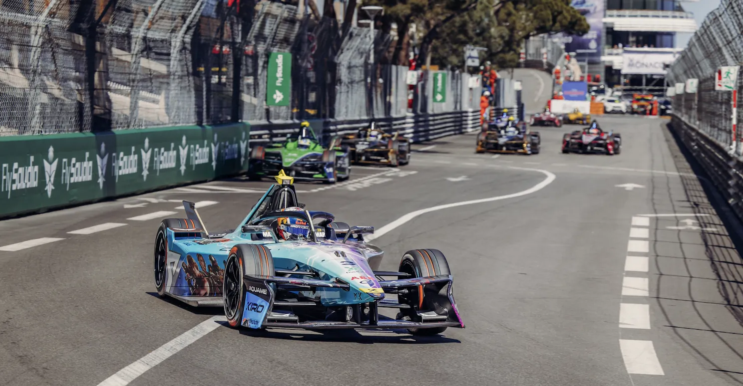 Formula E race car leading the pack on a Monaco street circuit track