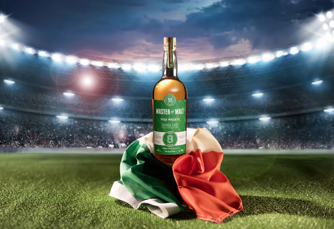 Master of Malt 8 Year Old Irish Whiskey bottle on Irish flag on a floodlit stadium pitch