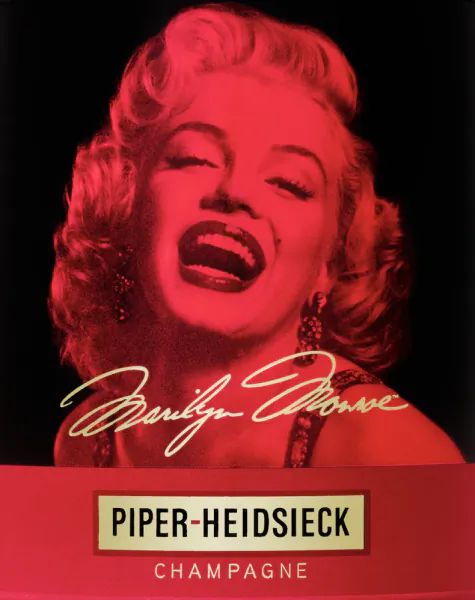 Marilyn Monroe smiling with eyes closed in red lighting, Piper-Heidsieck Champagne ad with her signature