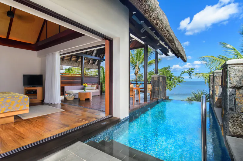 Luxury villa bedroom opening to private infinity pool overlooking ocean at Le Jadis Beach Resort Mauritius