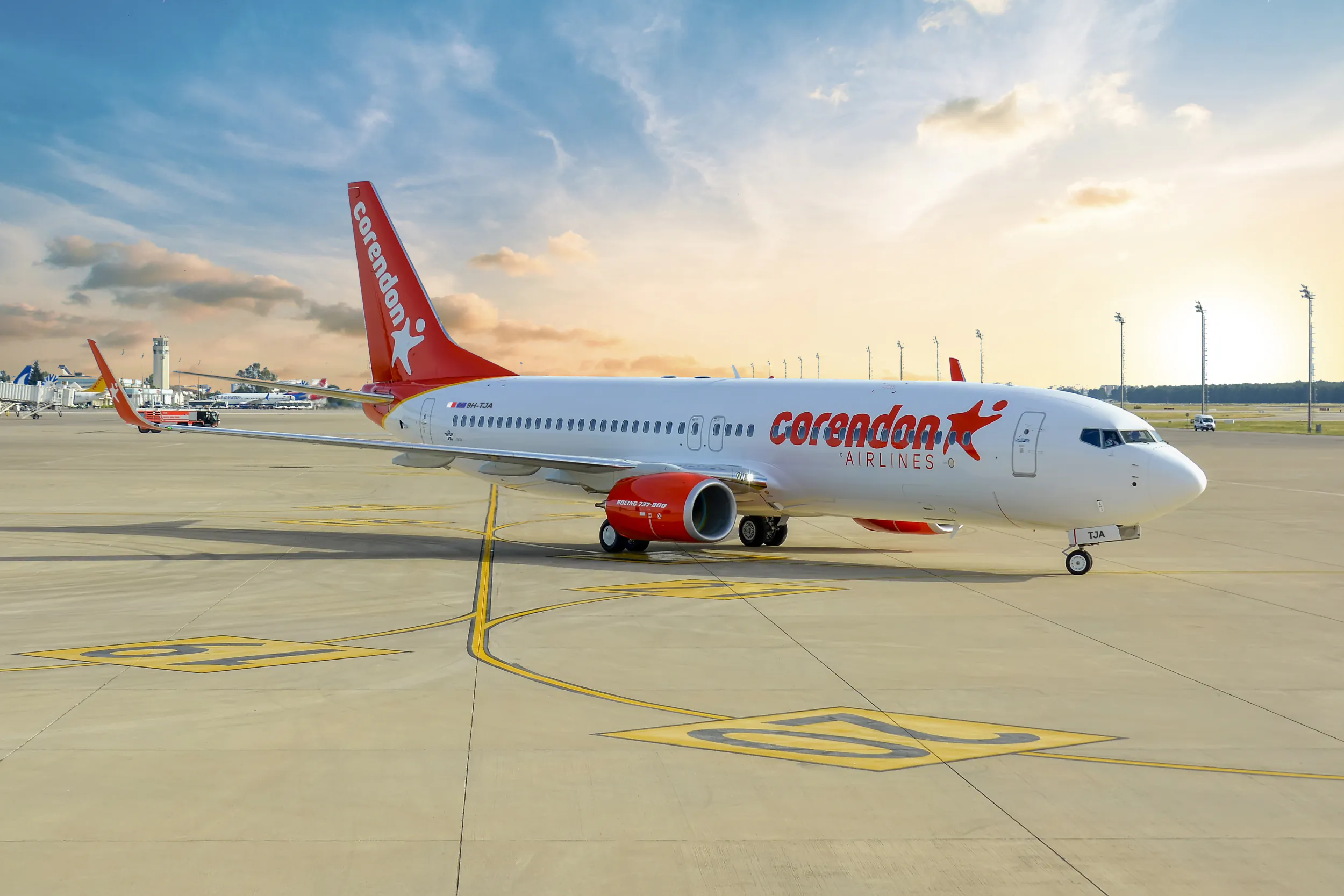 Corendon Airlines Boeing 737 on airport tarmac at sunrise with red tail logo
