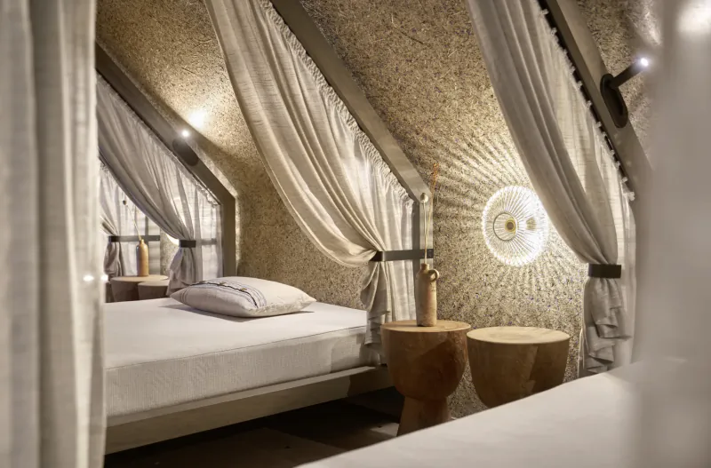 Cozy hotel bedroom with white bed, draped curtains, and textured walls at Platzl Hotel Munich