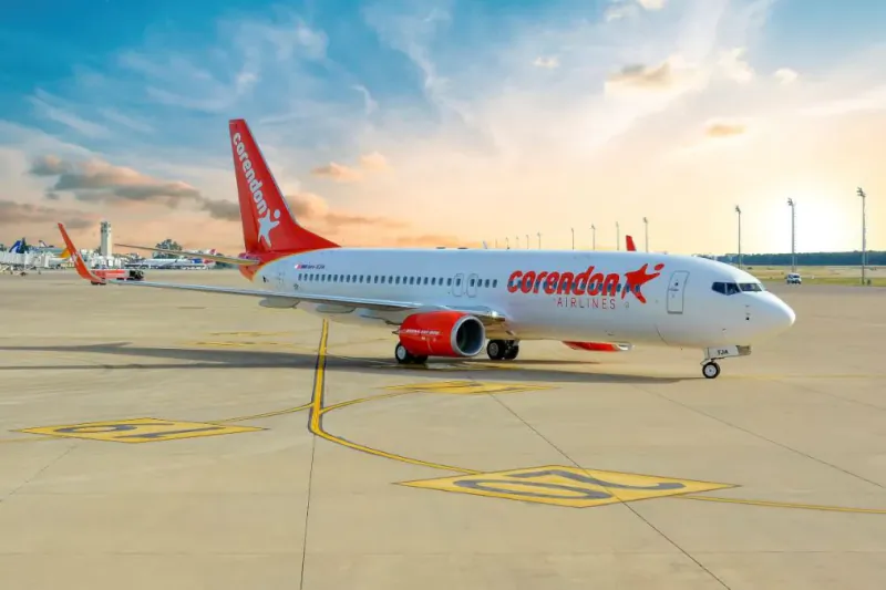 Corendon Airlines Boeing 737 parked on airport tarmac at sunset