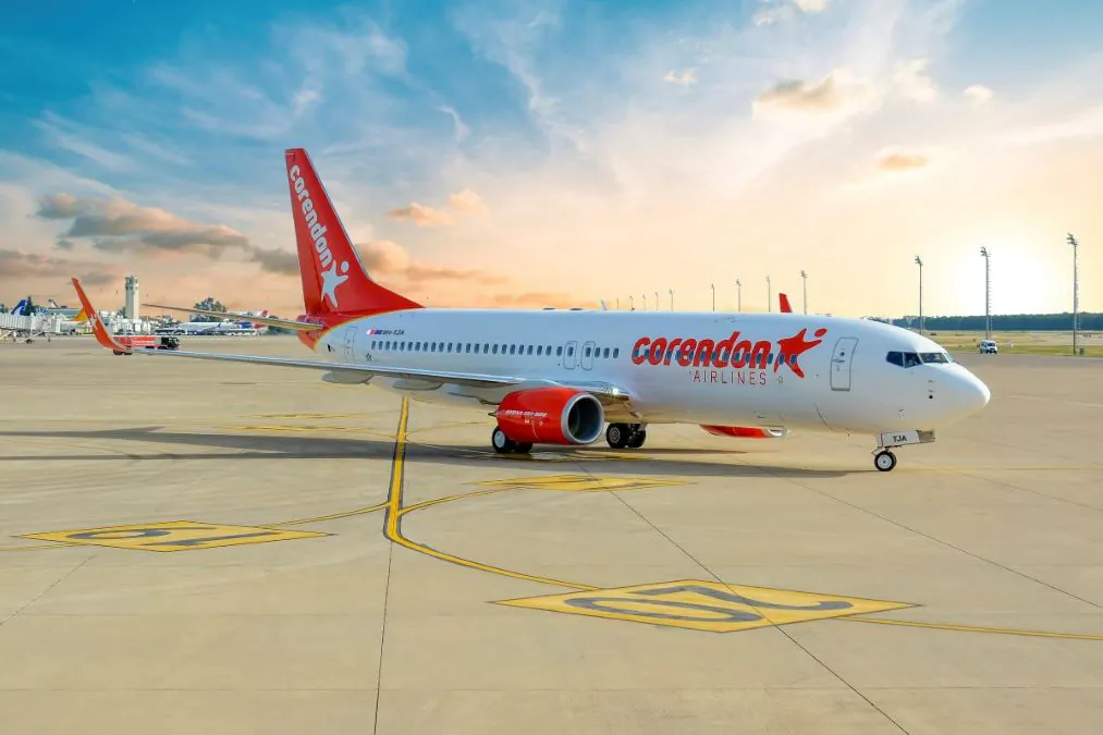 Corendon Airlines Boeing 737 parked on airport tarmac at sunset