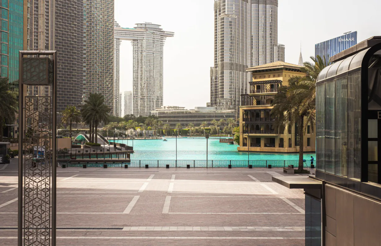 Dubai skyline with Marina Mall, Address Downtown, and Burj Khalifa overlooking turquoise lake and palm trees