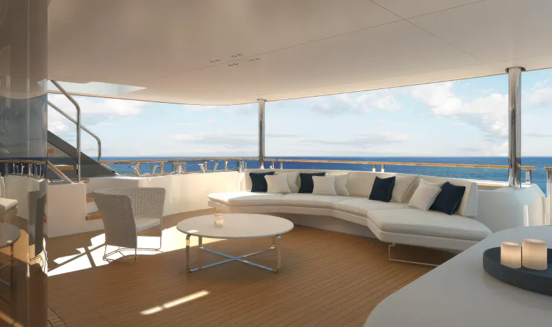 Luxury yacht deck with curved white sofa, round coffee table, and ocean view under a white canopy