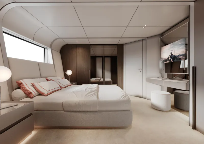 Modern yacht master bedroom with large white bed, wood accents, wall-mounted TV, and vanity area