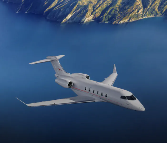 White private jet flying over blue water and green mountains