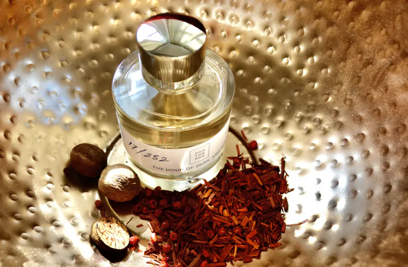 Parterre Fragrances perfume bottle on hammered metal with saffron threads and nutmeg pods