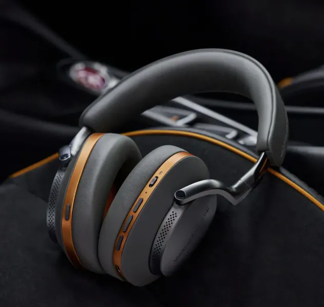 Bowers & Wilkins over-ear headphones with grey earcups and copper trim resting on a black leather case