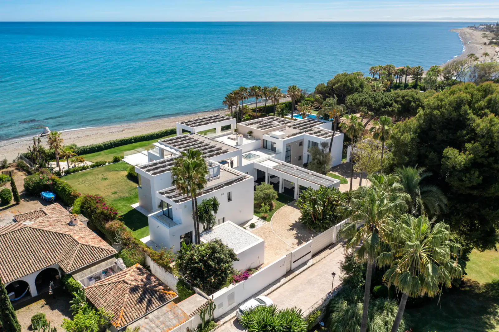 Aerial view of modern white luxury villa with pool overlooking the Mediterranean Sea and beach