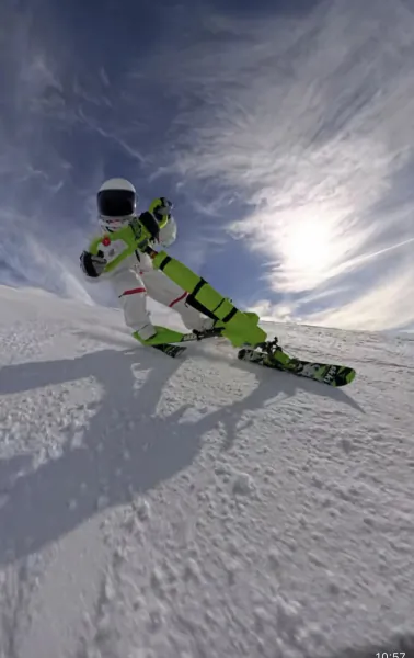 Skier in neon green and white suit carving down snowy slope under bright sun