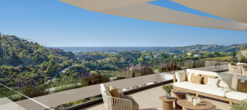 Modern luxury terrace overlooking the Mediterranean Sea and Marbella hills with outdoor sofas and chairs