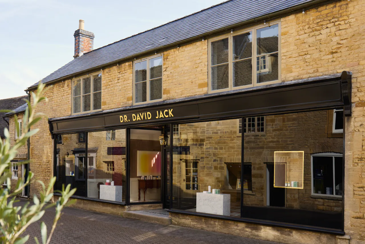 Dr. David Jack storefront in a stone building with large glass windows and black signage