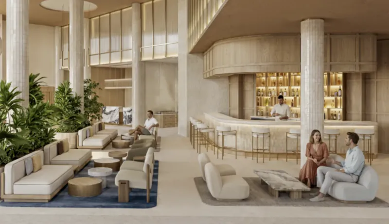 Modern luxury hotel lobby with marble bar, seating areas, and people relaxing in a bright, open space